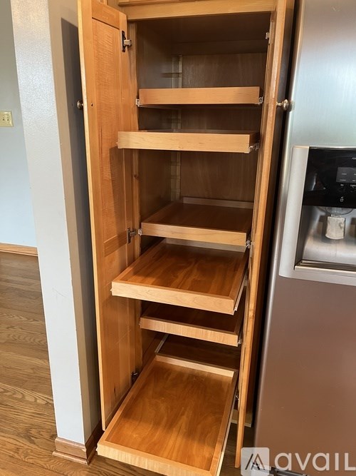 Empty wooden drawers in a kitchen cabinet.