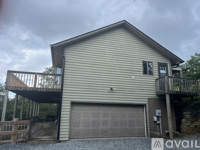 A house with a garage and a balcony.