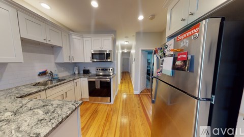 A kitchen with a refrigerator that has a sticker on it that says Supreme.