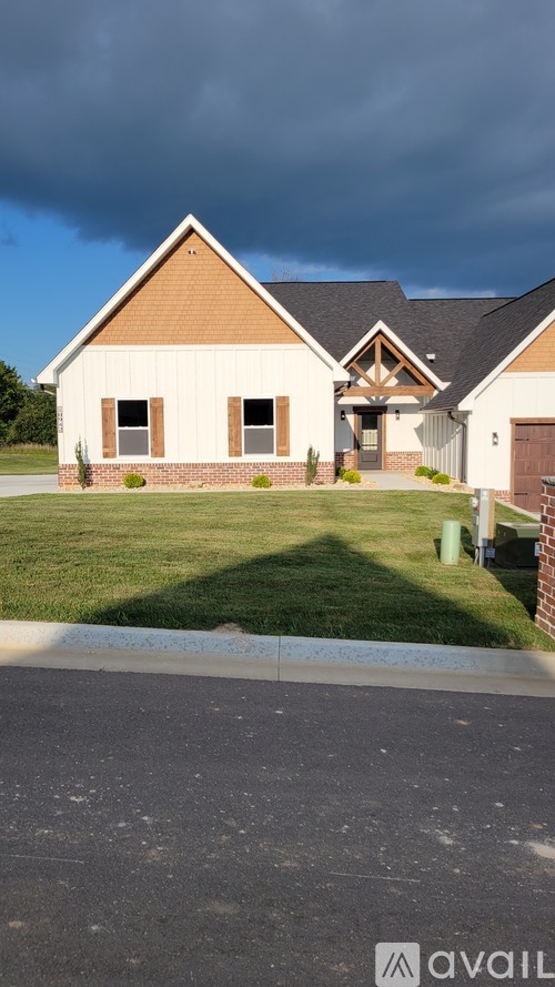 A house with a brown roof and a white wall with a brown door.