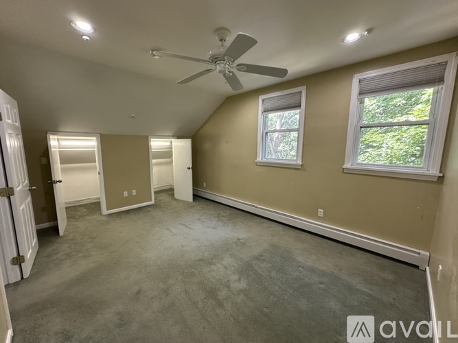 A room with a pool table and a red couch.
