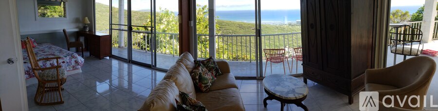 A living room with a view of the ocean.