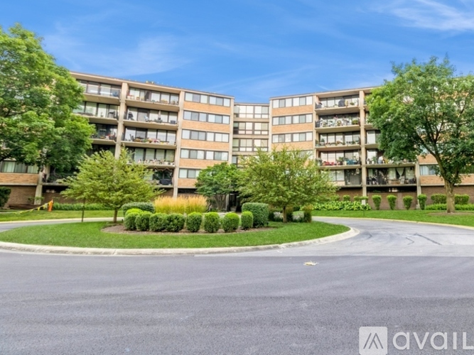 A large apartment complex with a central courtyard and a roundabout.