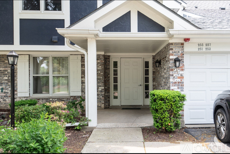 A house with a white door and a window with white frames.