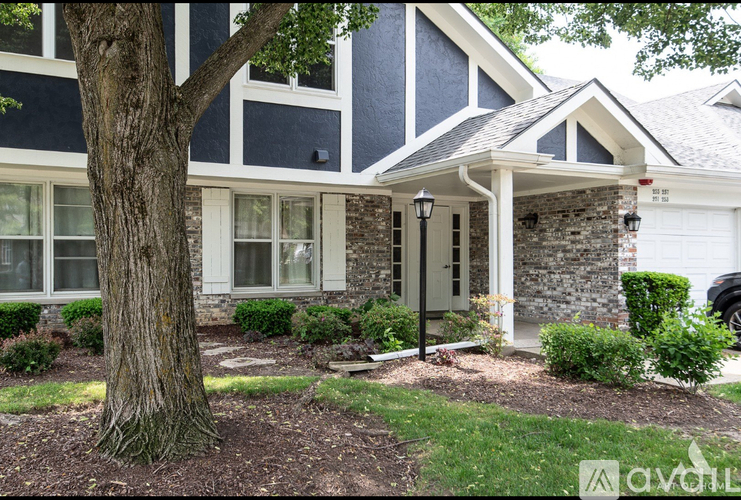 A house with a tree in front of it.