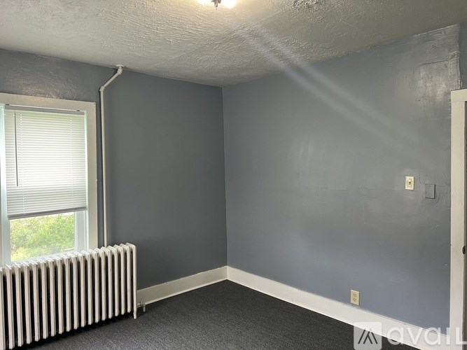 A room with grey walls and a white radiator.