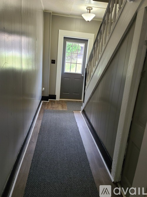 A hallway with a door at the end.