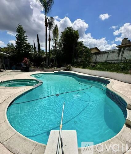 A pool with a diving board and a slide.