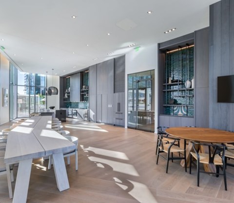 A modern dining room with a long table and chairs.