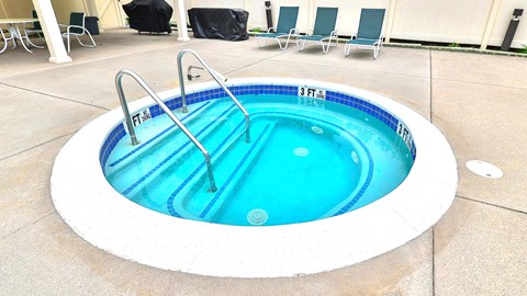 A round hot tub with a blue interior and a white exterior.