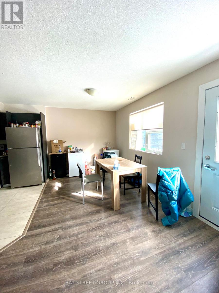 A kitchen with a table and chairs in the middle of the room.