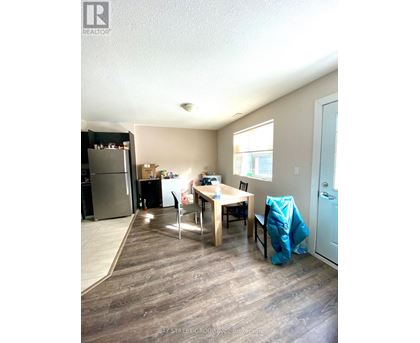 A kitchen with a table and chairs in the middle of the room.