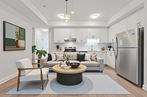 A modern kitchen with a refrigerator, sink, and cabinets.
