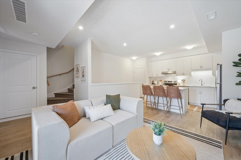 A living room with a white couch and a coffee table.