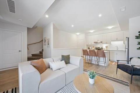 A living room with a white couch and a coffee table.
