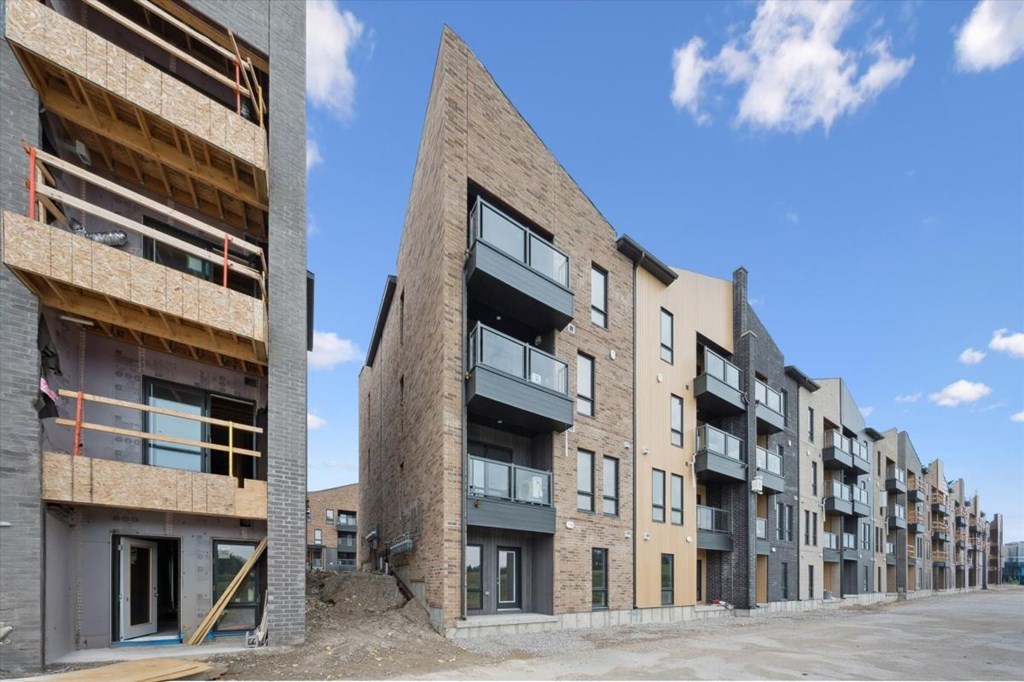 A row of new apartment buildings are under construction.
