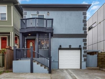 A two-story house with a balcony and a garage.