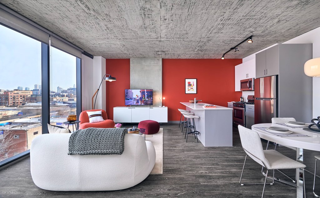 A modern living room with a white bean bag chair and a grey throw pillow.