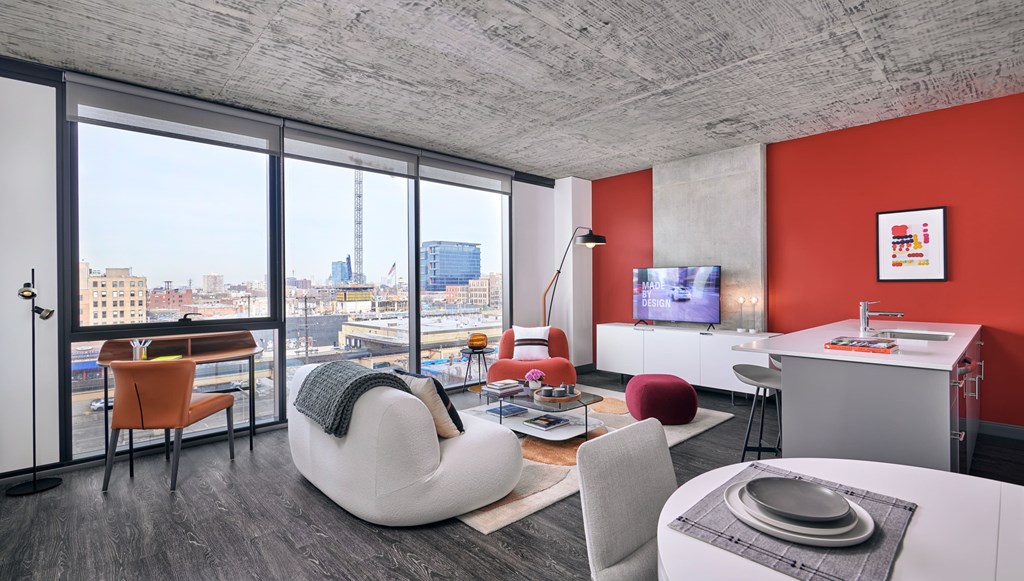 A modern living room with a large window overlooking the city.