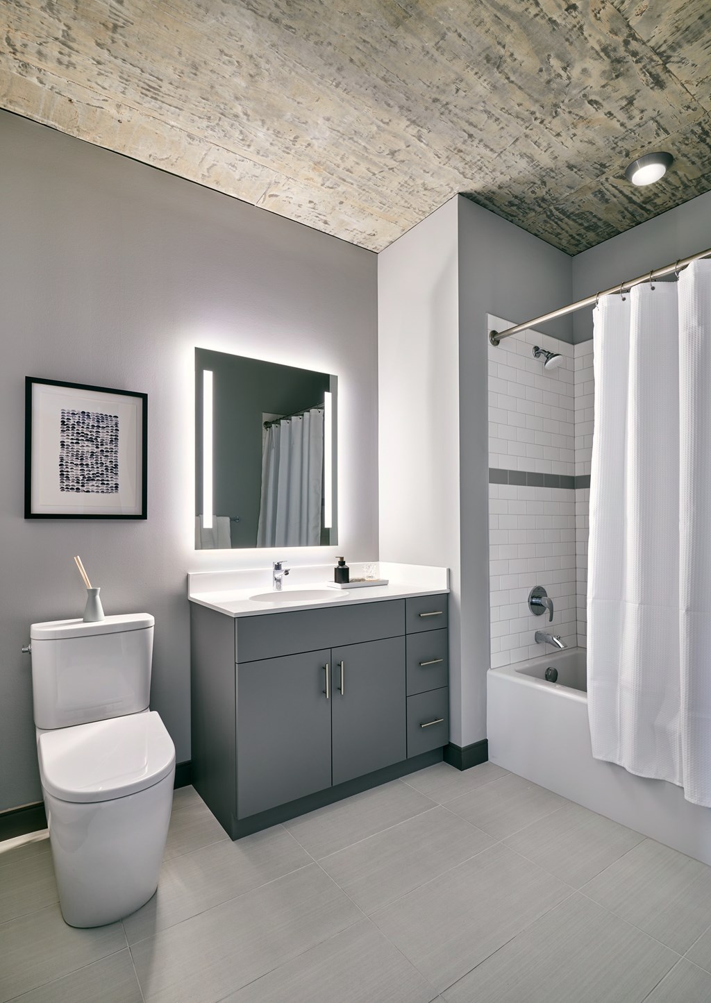 A bathroom with a white toilet, a sink, and a shower.