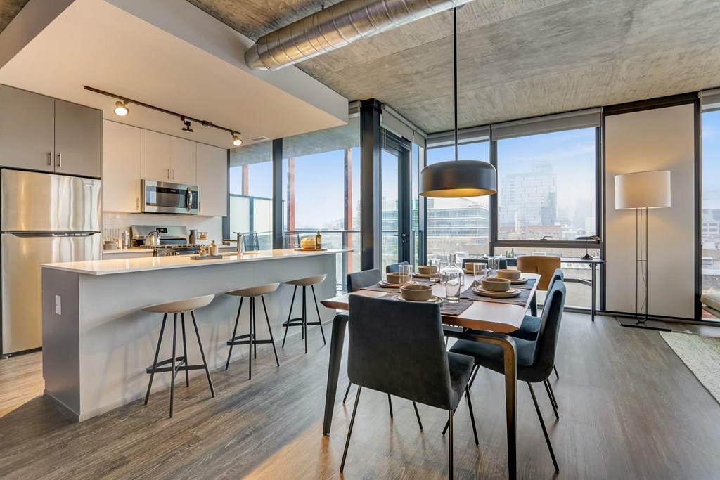 A modern kitchen with a dining table and chairs.