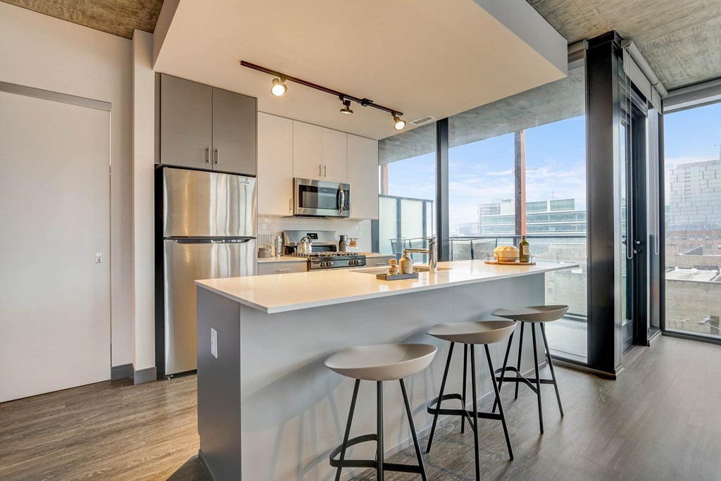 A modern kitchen with a bar stool.