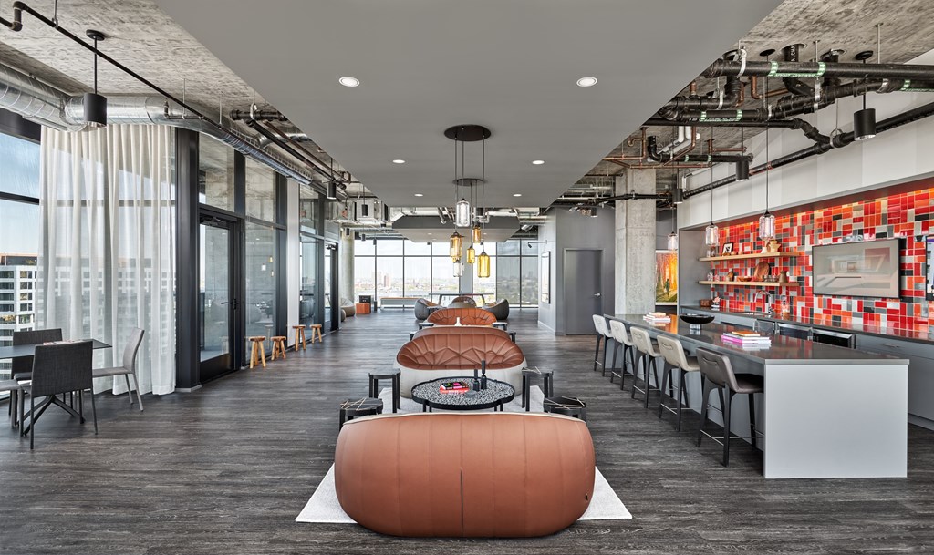 A modern office space with a long table and chairs.