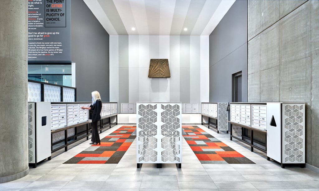 A woman in a black outfit stands in a hallway with a sign that says "The point of choice.".