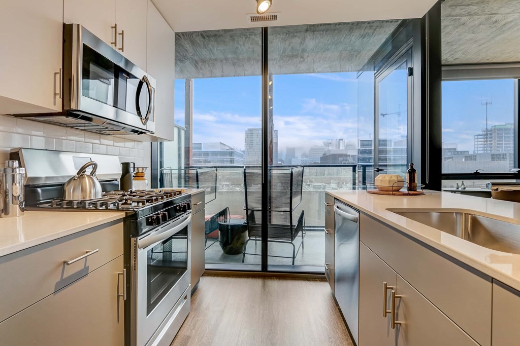 A modern kitchen with a view of the city.