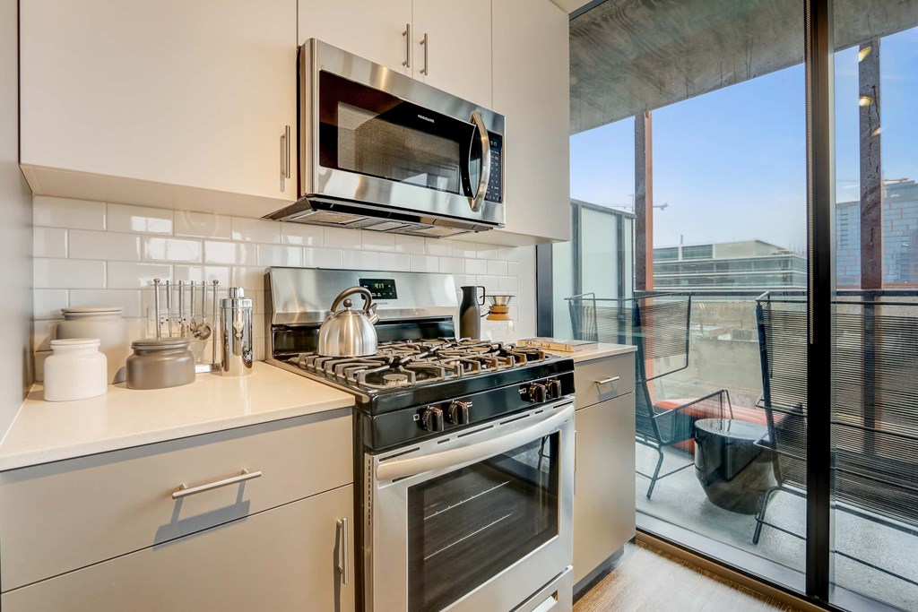 A modern kitchen with a stove, oven, and microwave.