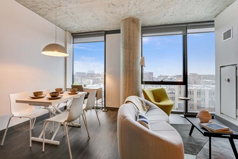 A modern living room with a dining table and chairs.