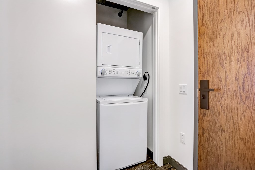A white dishwasher is built into a wall in a kitchen.