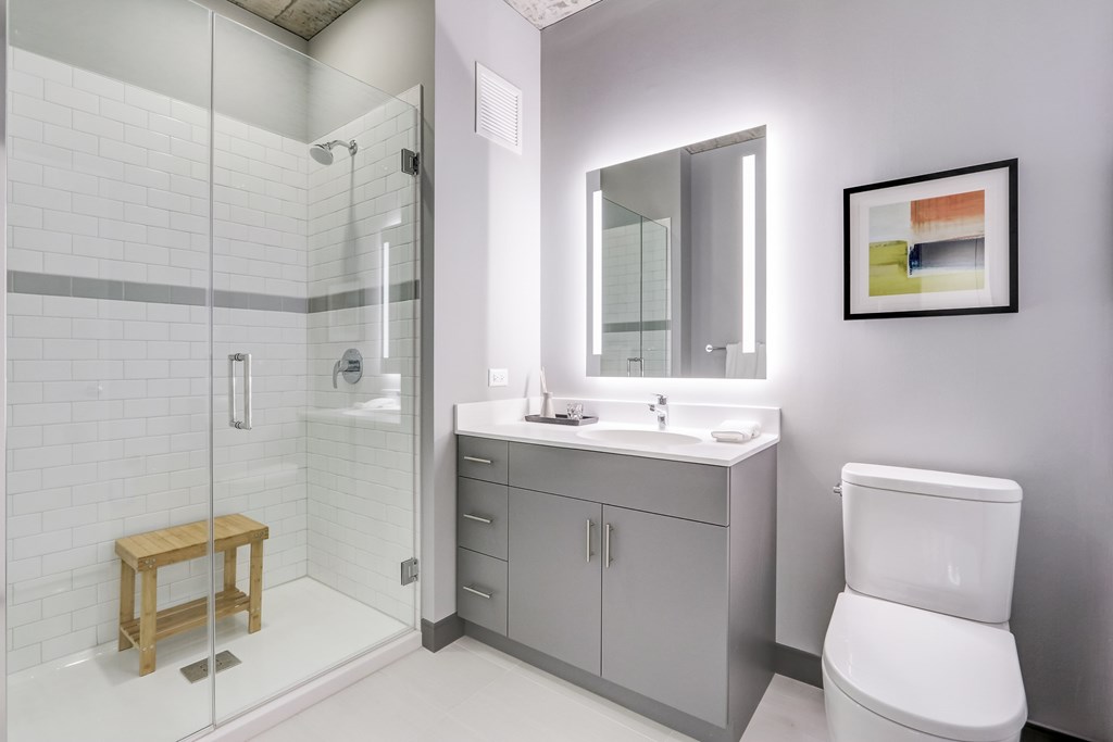 A bathroom with a toilet, sink, and shower.