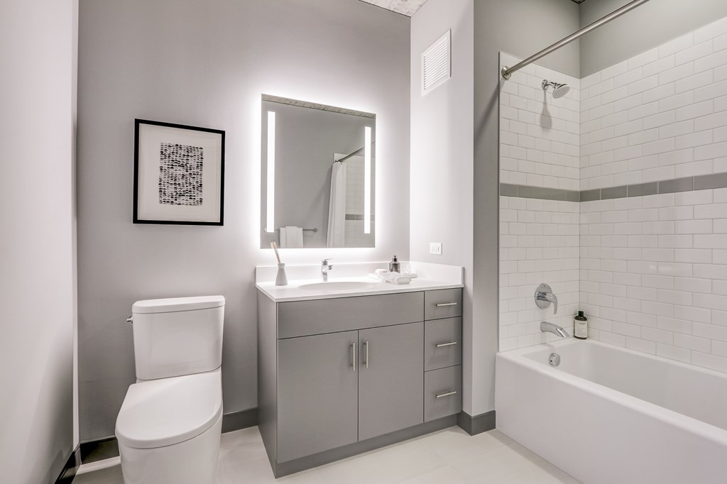 A white bathroom with a toilet, sink, and bathtub.