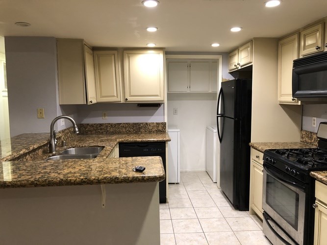 A kitchen with granite countertops and stainless steel appliances.