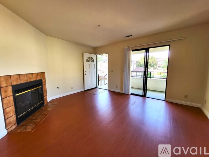 A living room with a fireplace and sliding glass doors.