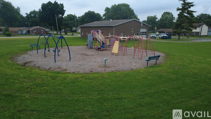 A playground with a swing set and a slide.