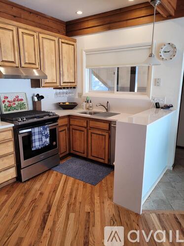 A kitchen with wooden cabinets and a white fridge.