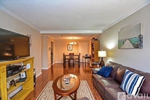 A living room with a brown couch and a wooden coffee table.