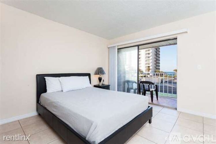 A bedroom with a large bed and a view of the city.