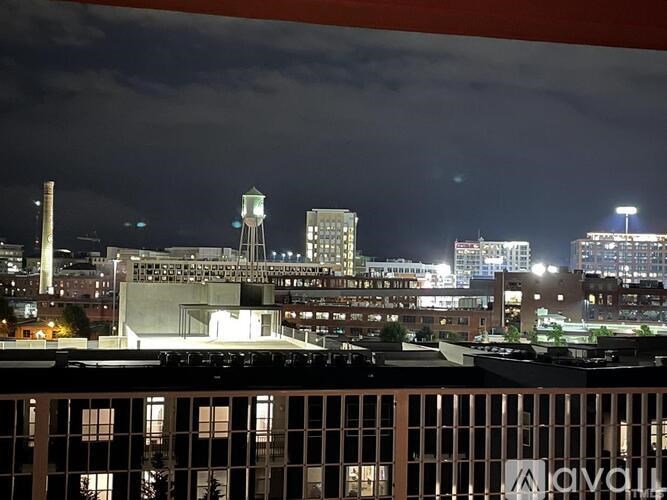 A cityscape at night with a prominent clock tower.