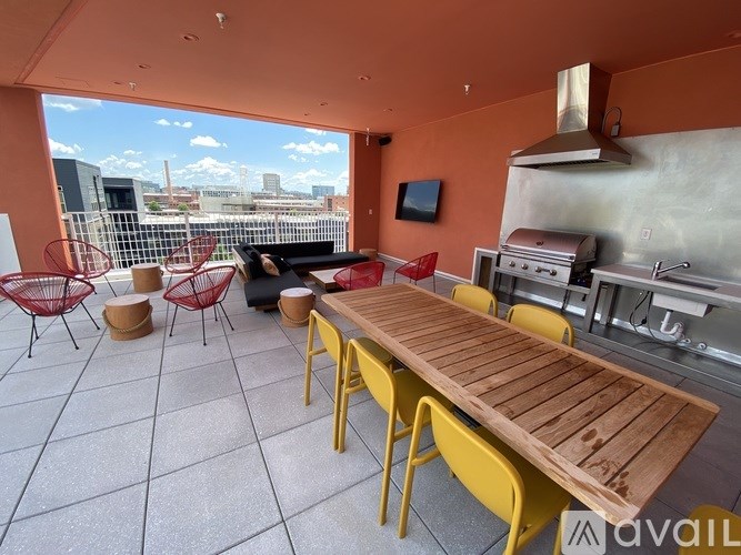 A patio with a table and chairs overlooking a cityscape.
