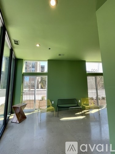 A room with green walls and a bench.