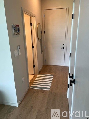 A hallway with a striped rug on the floor.