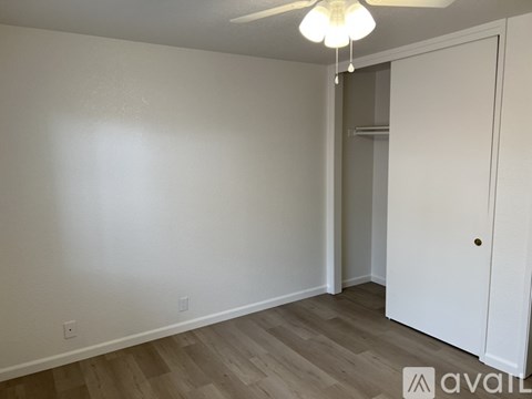 A room with a white door and a light on the ceiling.