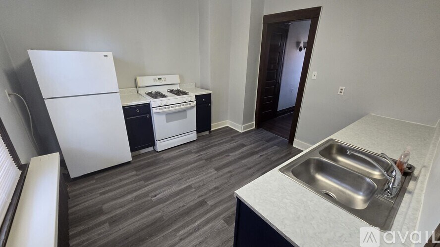 A kitchen with a white fridge, a white oven, and a white dishwasher.