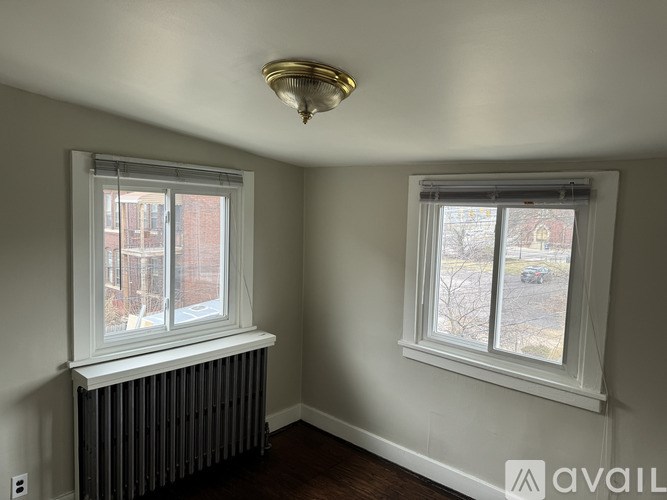 A room with a white ceiling and a window with a white frame.