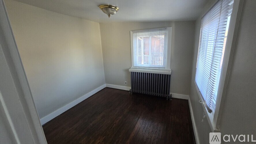 A room with a window and a radiator on the wall.
