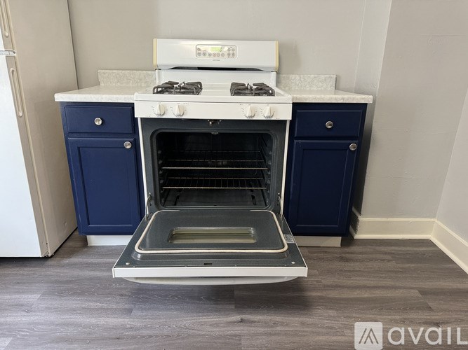 A white and blue oven with a drawer underneath it.