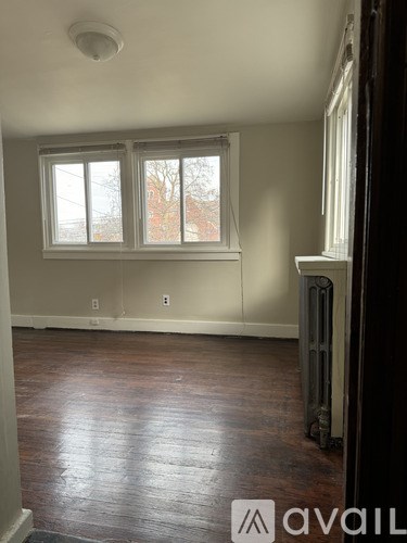 A room with wood floors and a window.